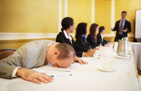 Businessman Sleeping During Conference Presentation